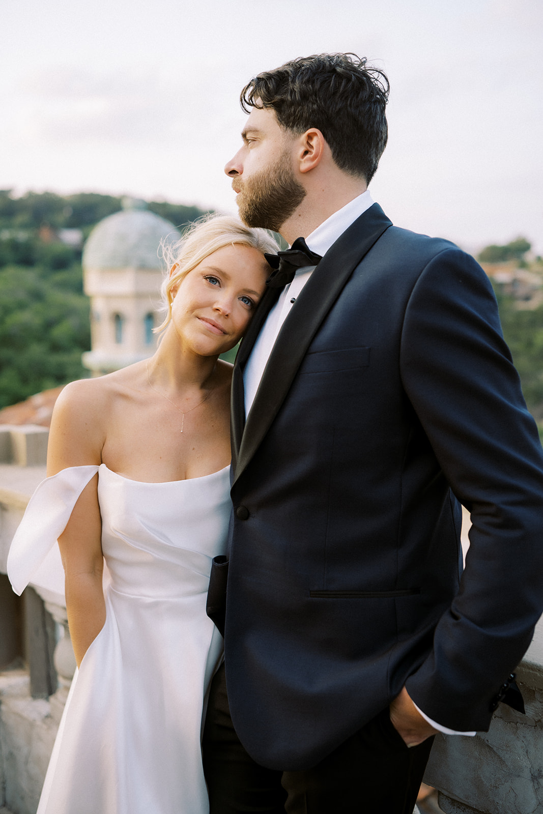 bride and groom on a balcony at their destination